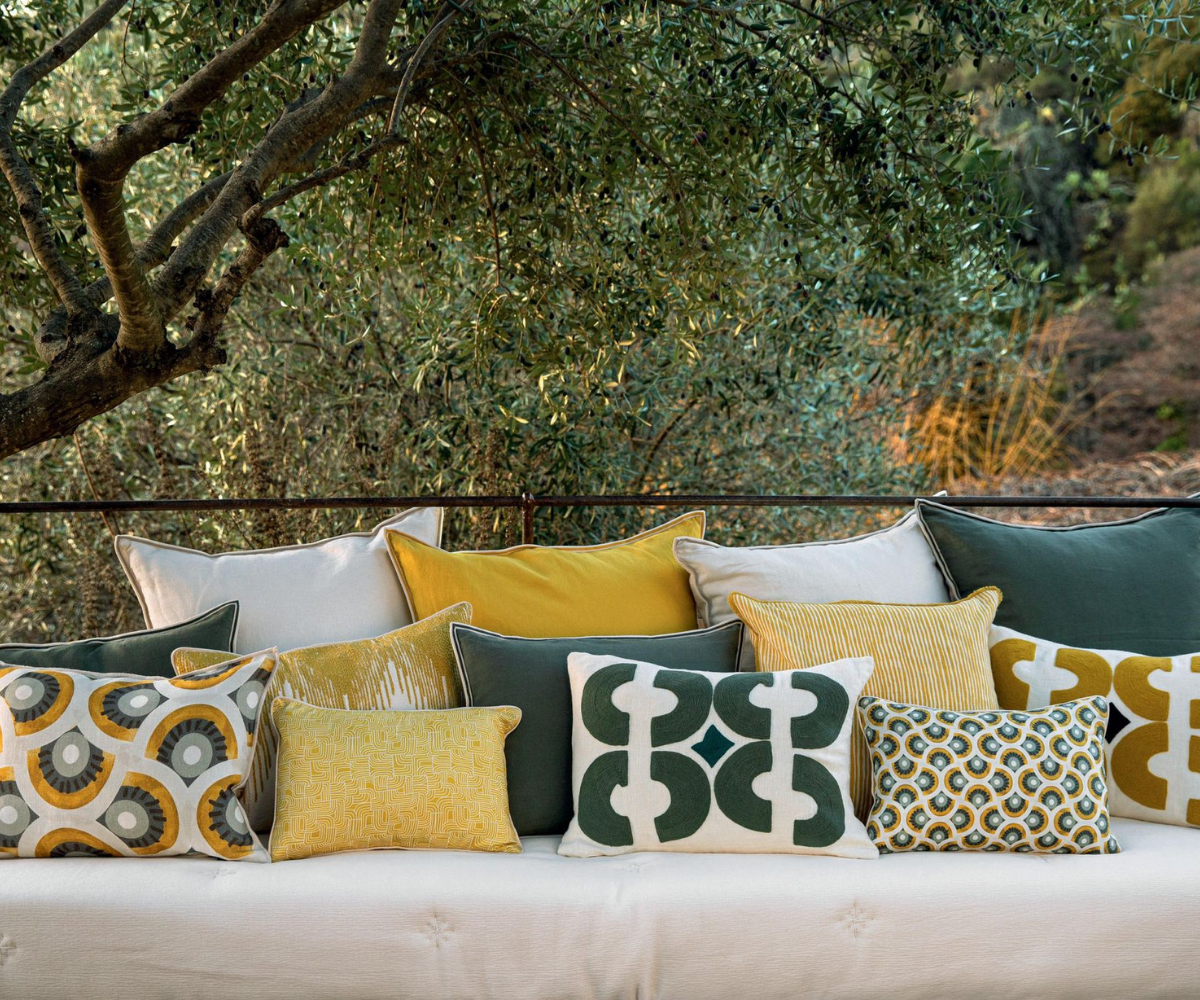 Maison France interior with cushions on a sofa and an olive tree